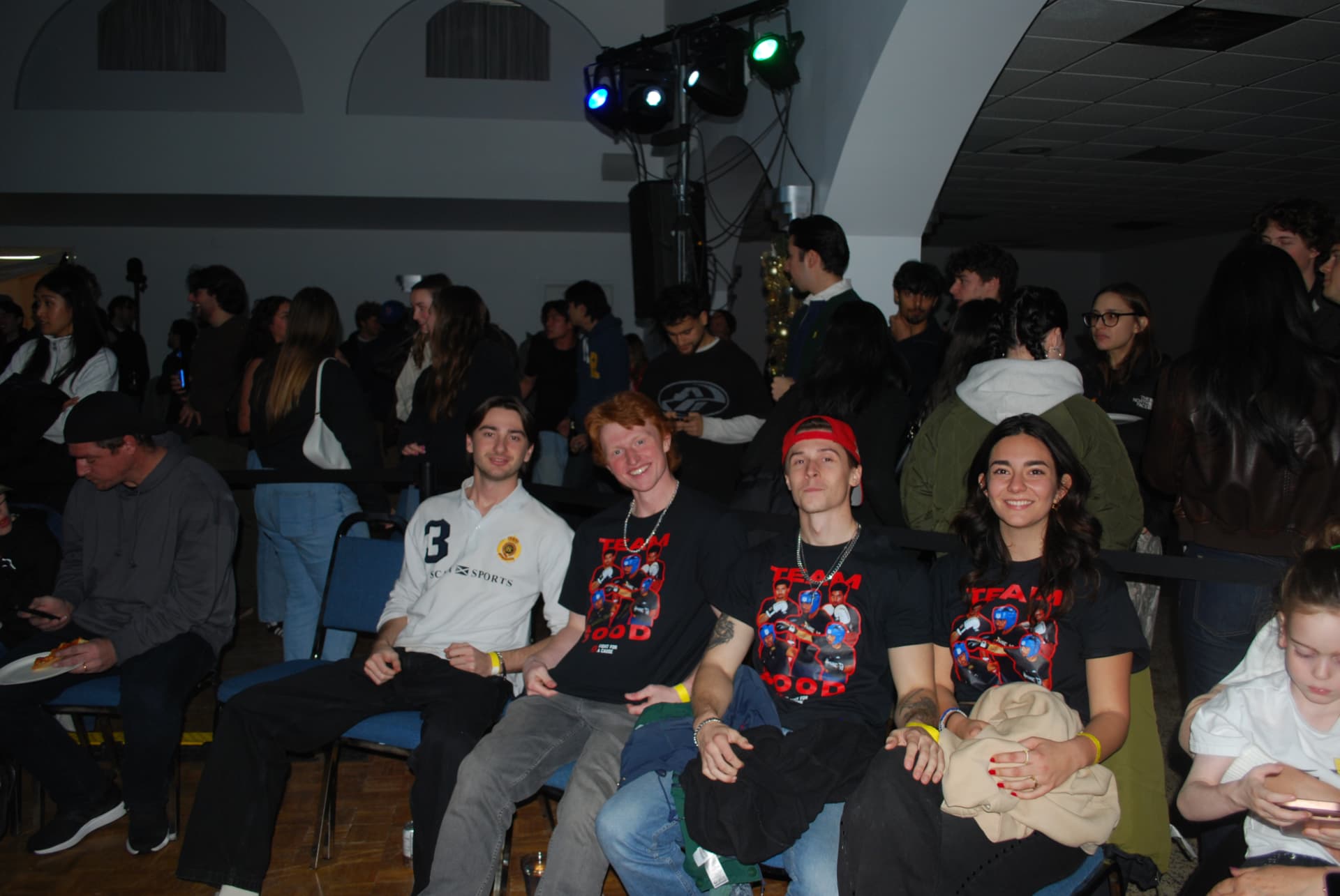 Supporters seated in FFAC team shirts at fight night
