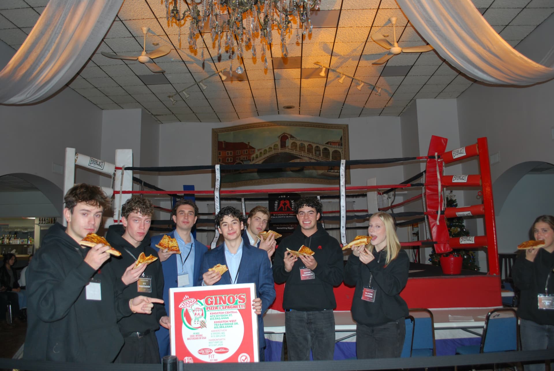 Guests eating pizza in front of the ring at FFAC