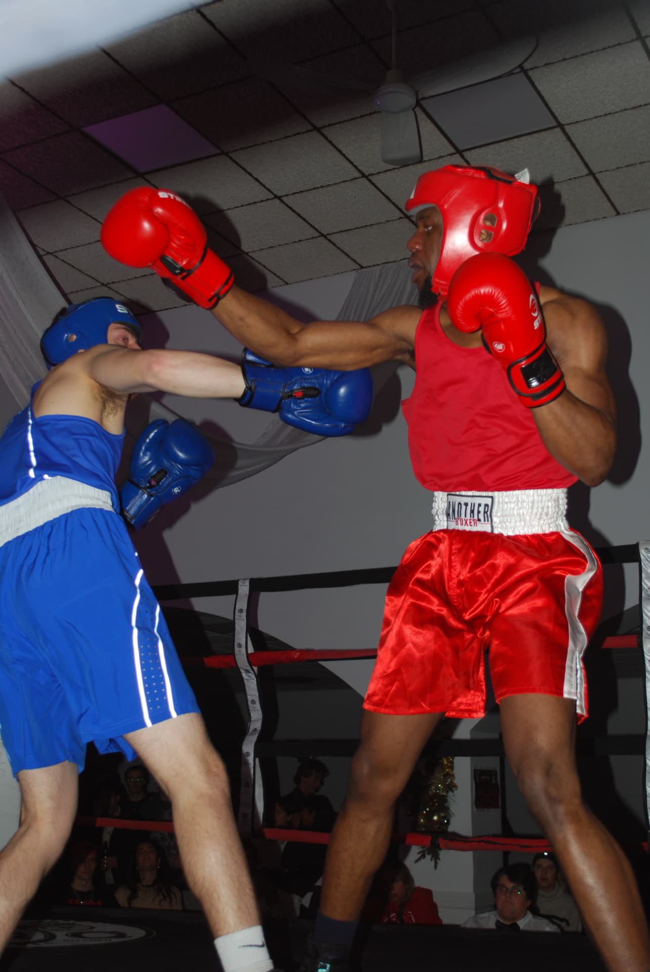 Two student boxers exchanging punches in the ring at FFAC